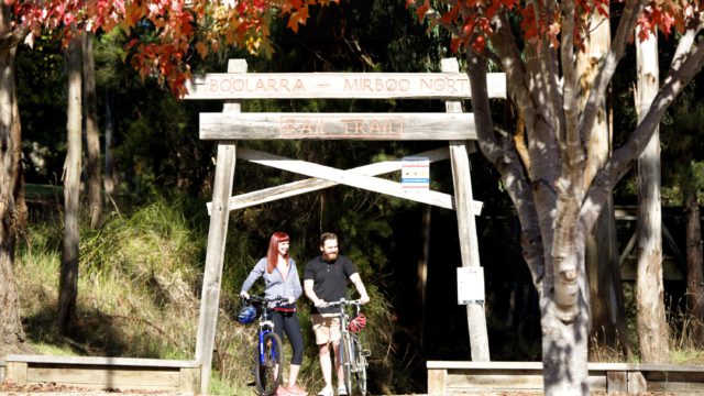 cycling at the entrance of Grand Ridge Rail Trail
